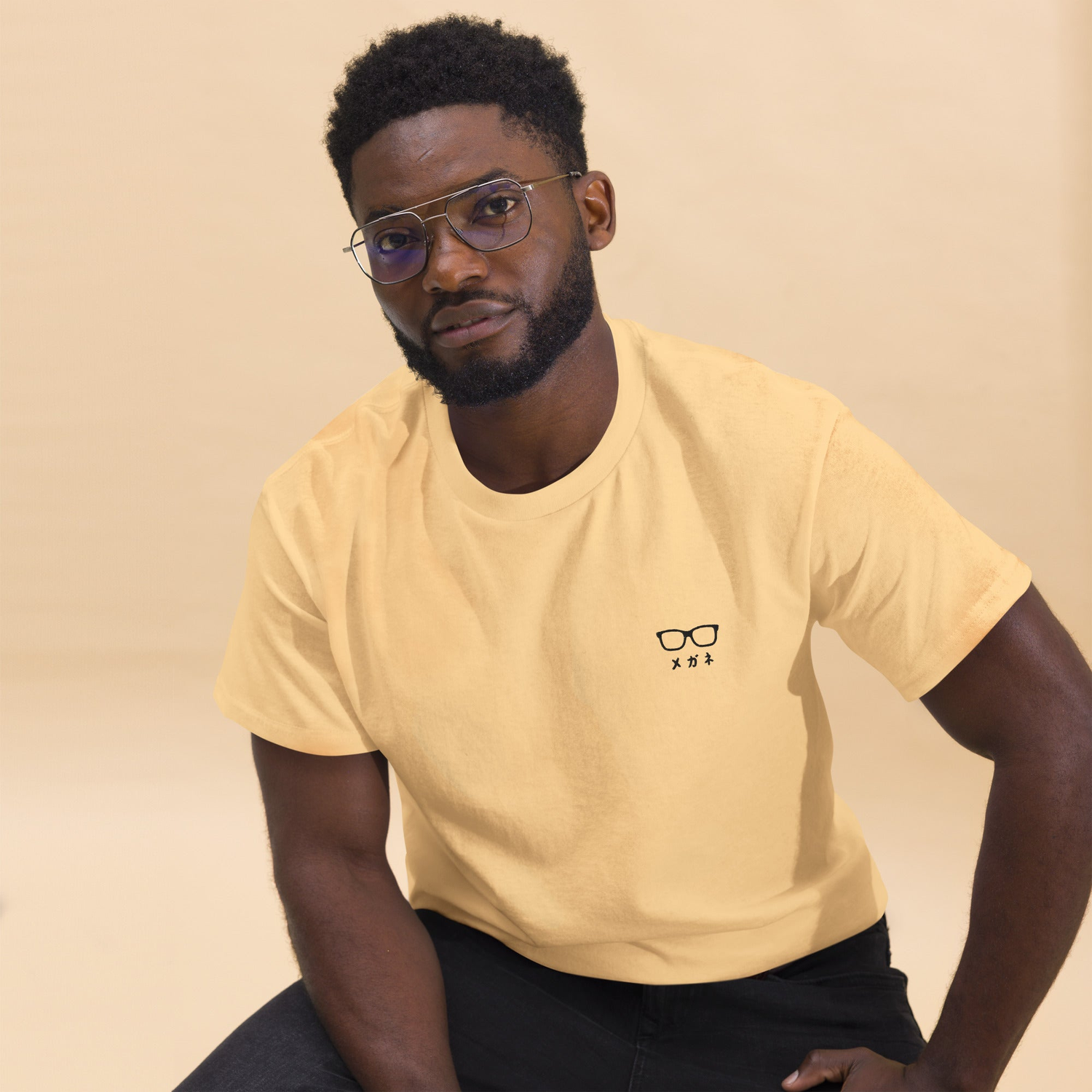 a guy is wearing Japanese letter t-shirt